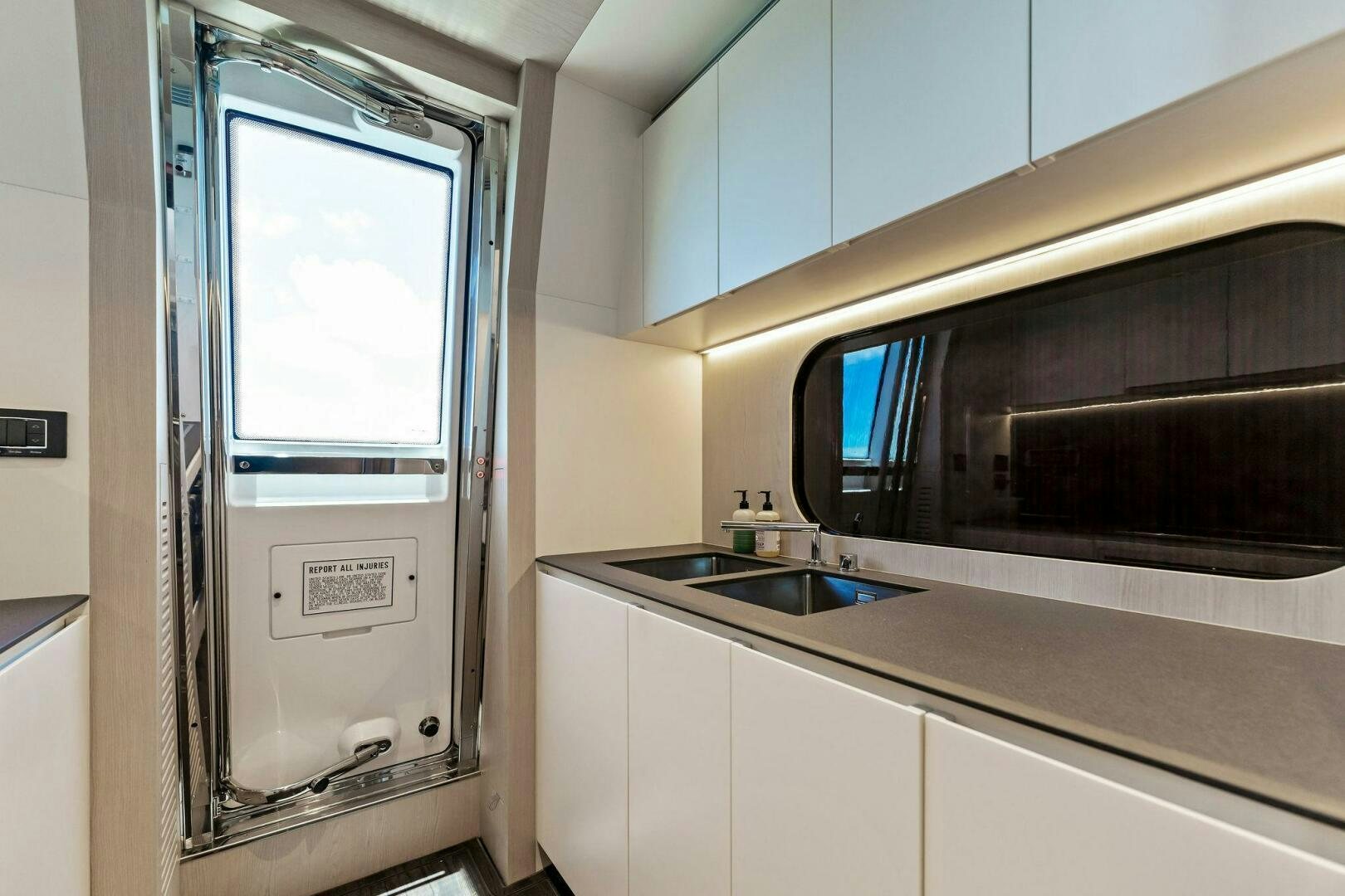 a large metal door in a kitchen aboard LIMITLESS Yacht for Sale