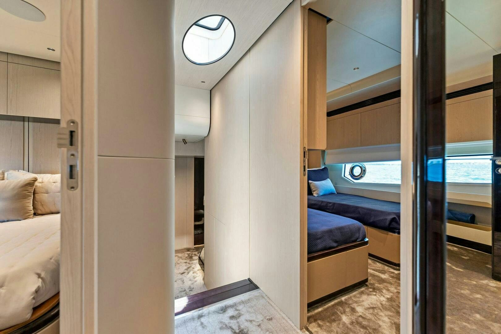 a room with a bed and a door aboard LIMITLESS Yacht for Sale