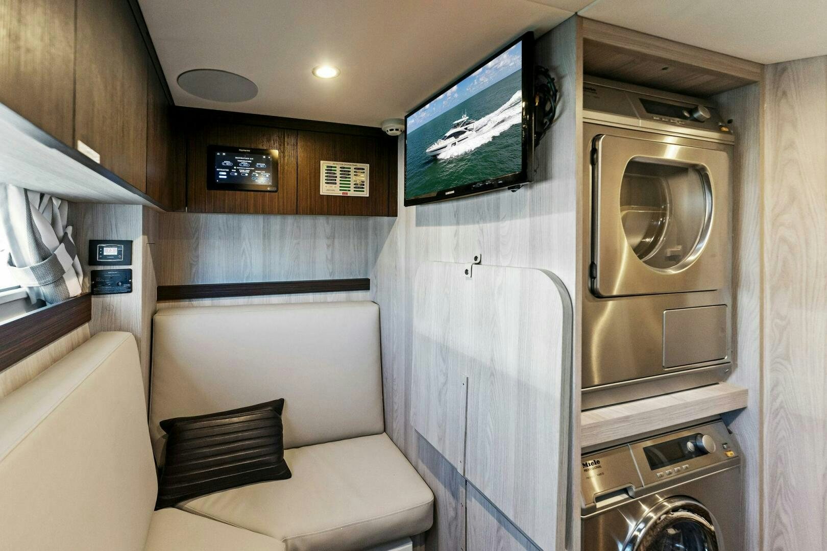 a small living room with a couch aboard LIMITLESS Yacht for Sale