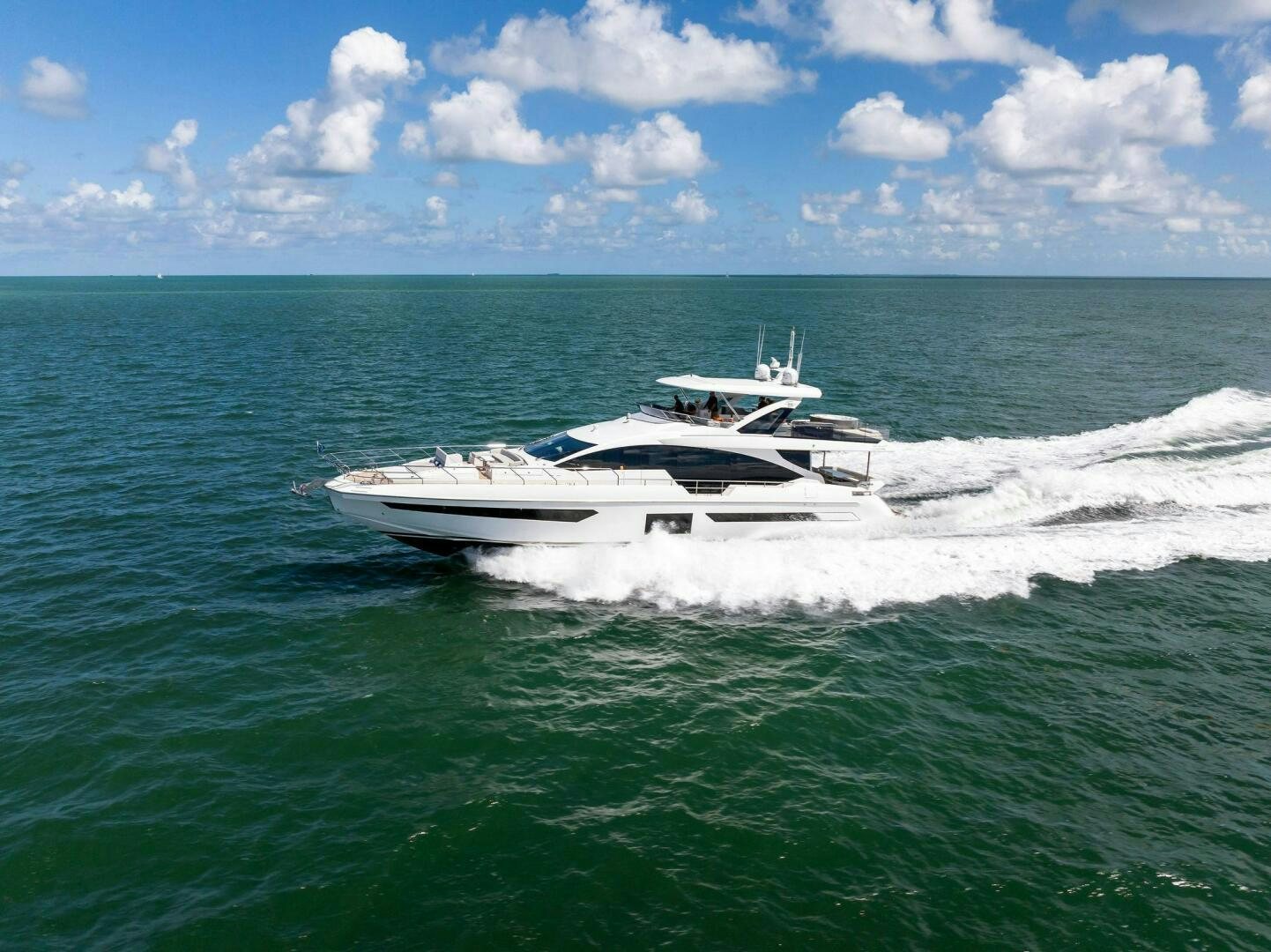 a white boat in the water aboard LIMITLESS Yacht for Sale