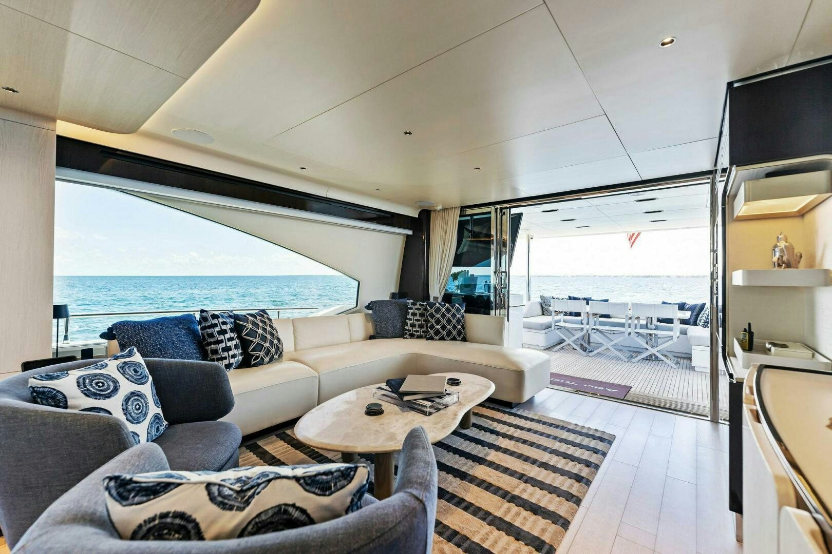 a living room with a large window aboard LIMITLESS Yacht for Sale