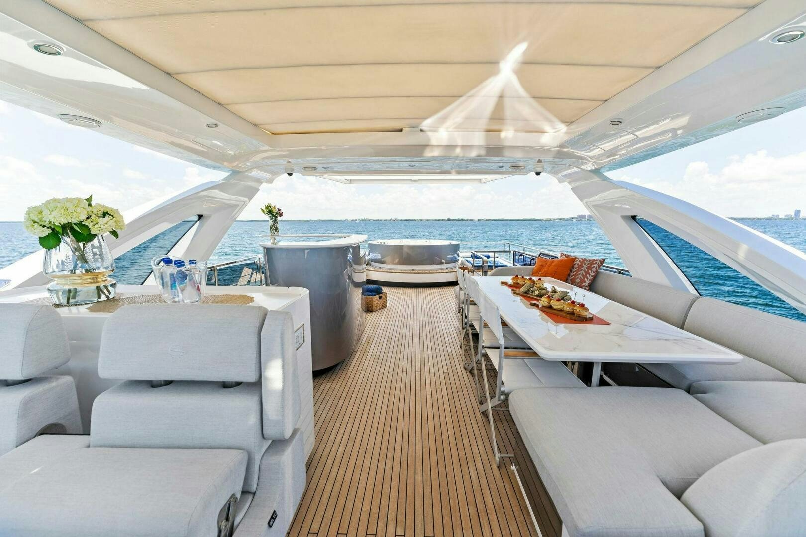 a boat with a table and chairs aboard LIMITLESS Yacht for Sale