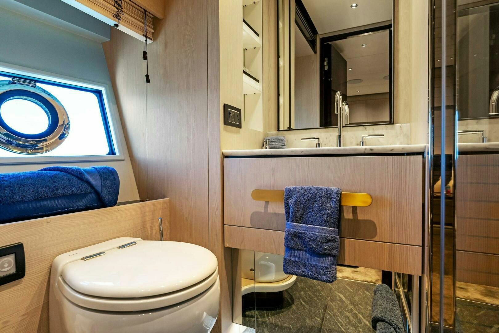 a bathroom with a shower and toilet aboard LIMITLESS Yacht for Sale