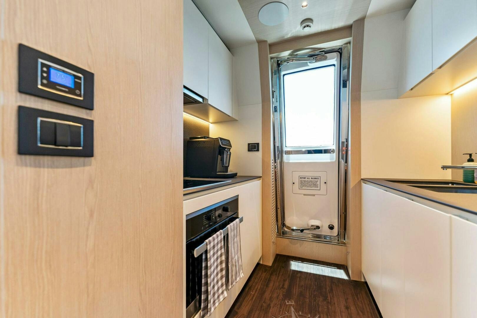 a kitchen with a sliding glass door aboard LIMITLESS Yacht for Sale