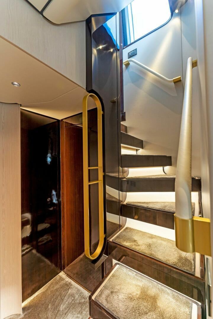 a staircase with metal railings aboard LIMITLESS Yacht for Sale