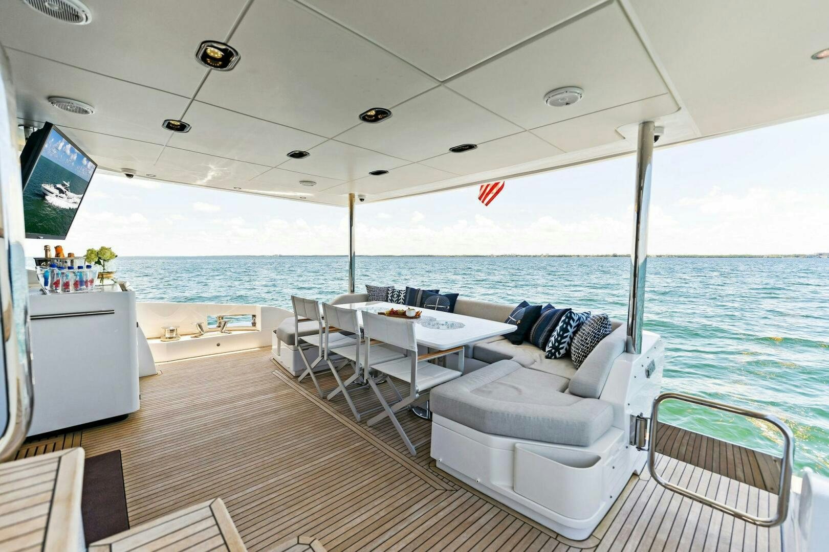 a room with a couch and a table and chairs aboard LIMITLESS Yacht for Sale
