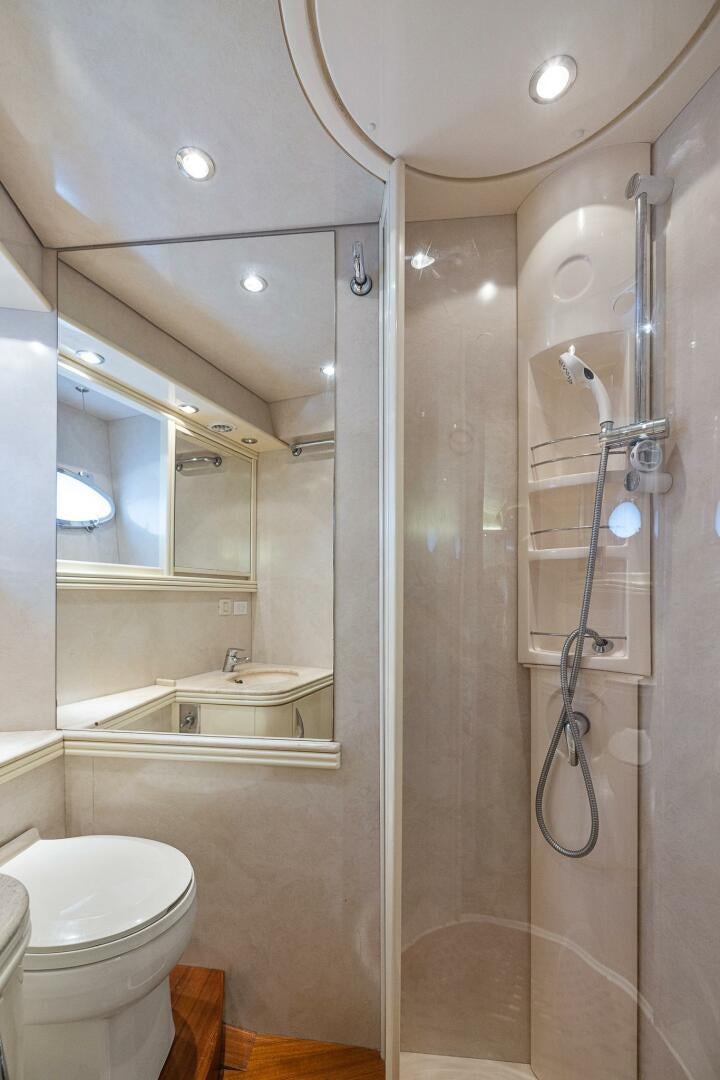 a bathroom with a glass shower aboard ROOSTERTAIL Yacht for Sale