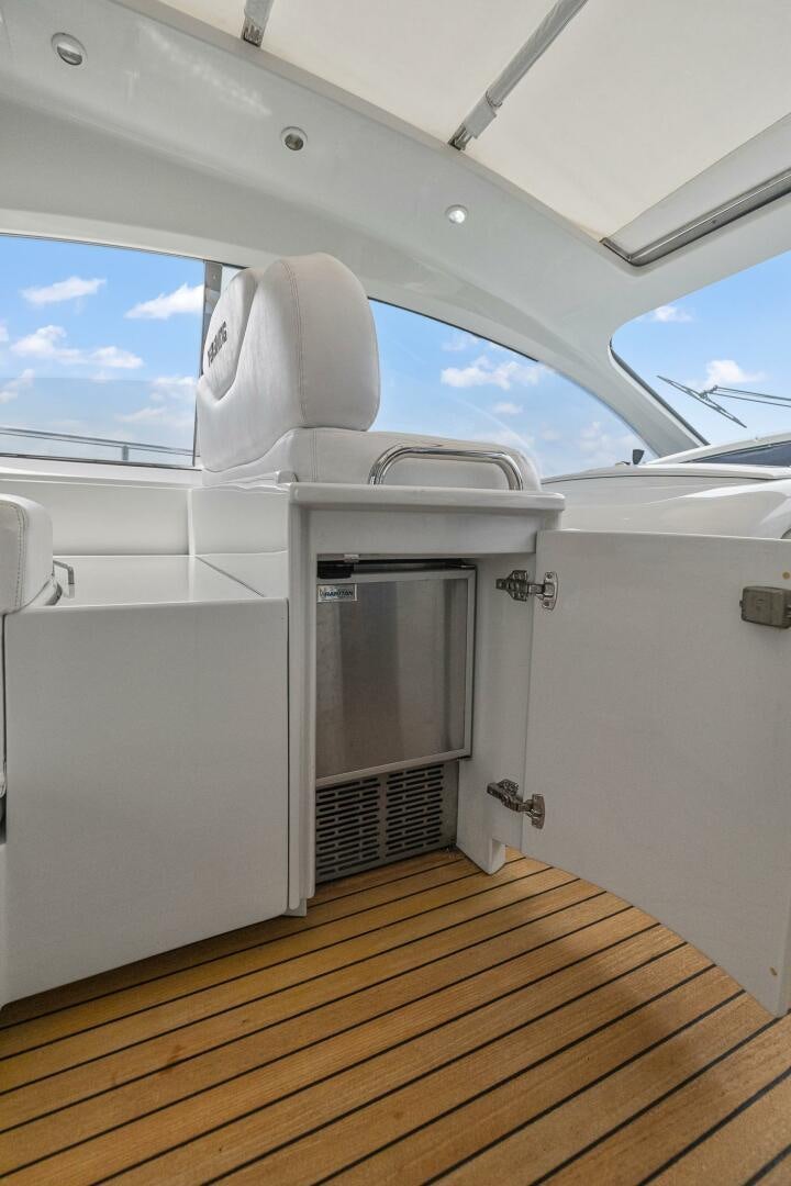 a white boat with a door open aboard ROOSTERTAIL Yacht for Sale