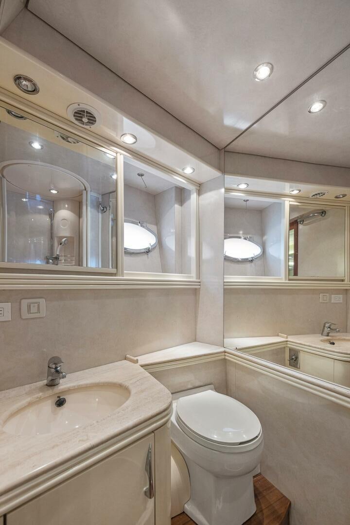 a bathroom with a toilet and a sink aboard ROOSTERTAIL Yacht for Sale