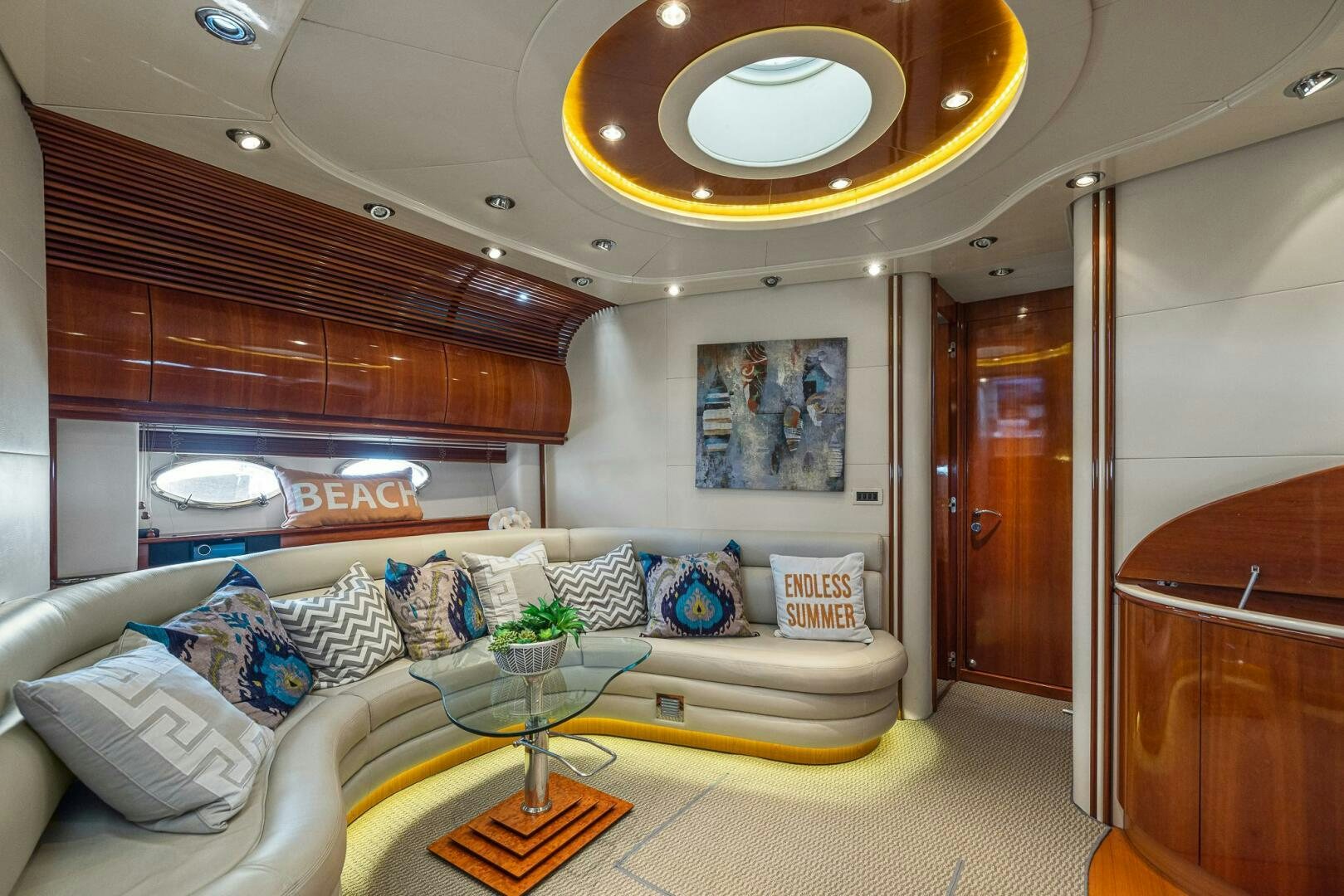 a living room with a large mirror aboard ROOSTERTAIL Yacht for Sale
