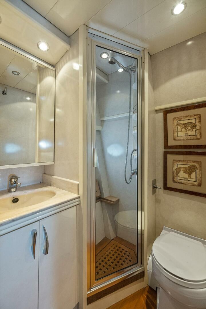 a bathroom with a glass shower door aboard ROOSTERTAIL Yacht for Sale