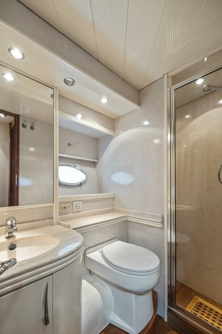 a bathroom with a glass shower aboard ROOSTERTAIL Yacht for Sale