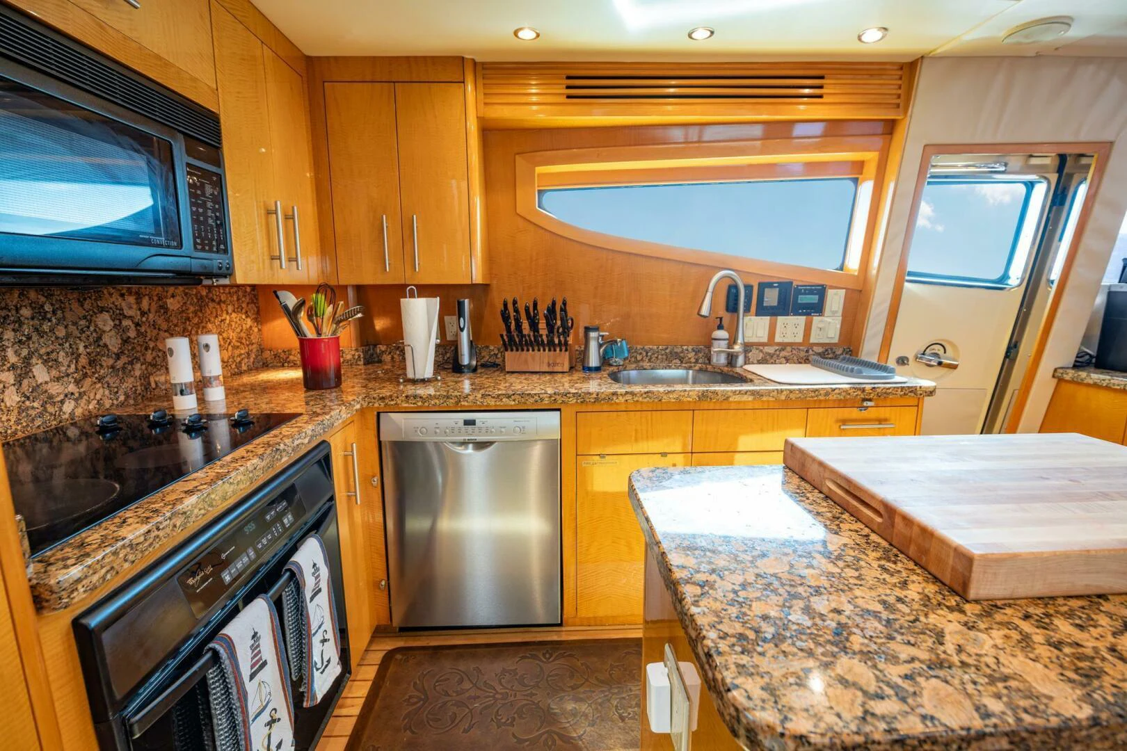 a kitchen with wooden cabinets aboard TIME-2 FLY Yacht for Sale