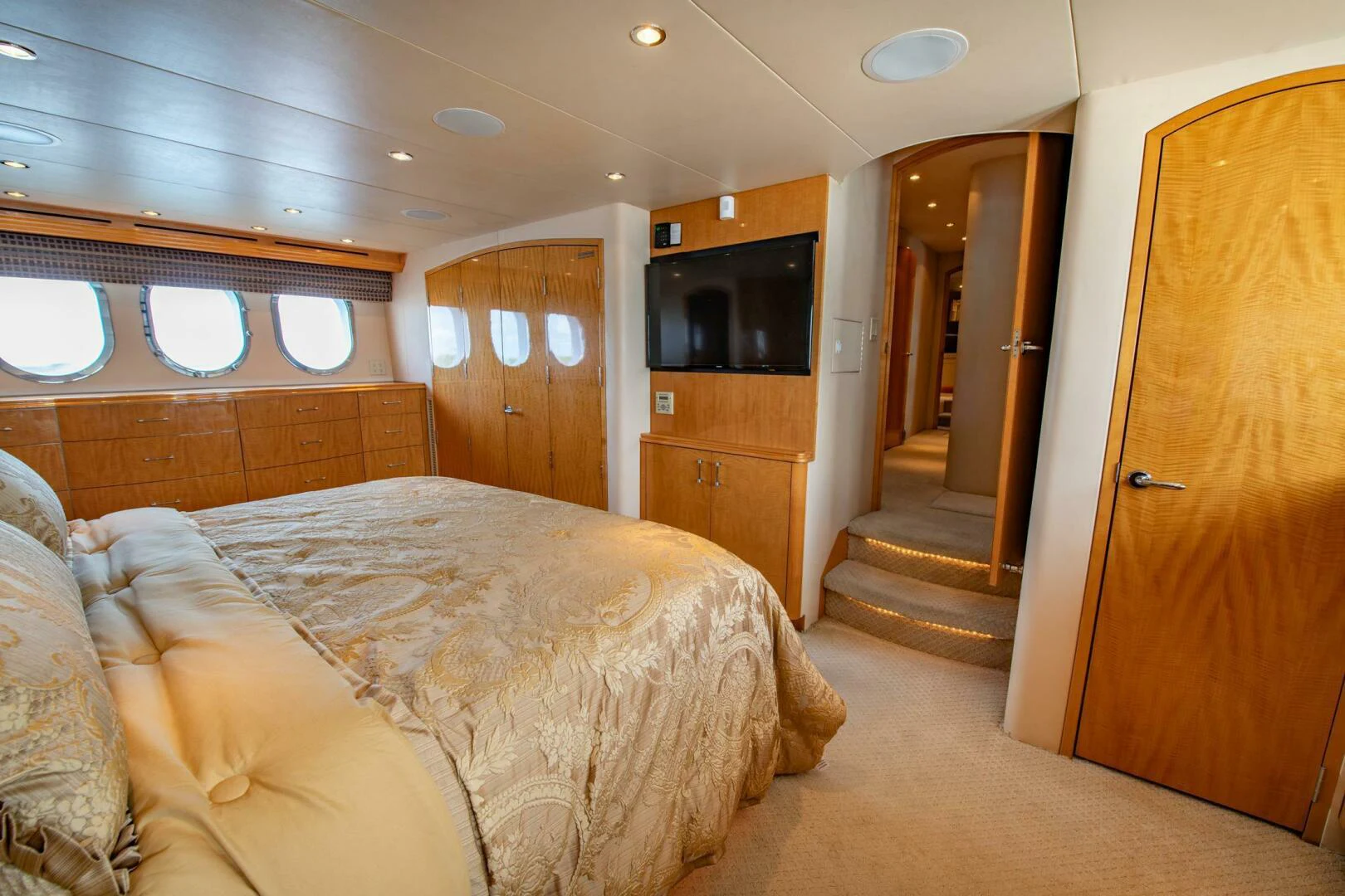 a bedroom with a bed and a television aboard TIME-2 FLY Yacht for Sale