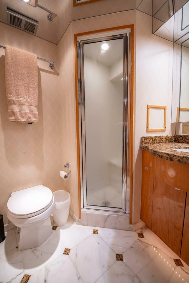 a bathroom with a glass shower door aboard TIME-2 FLY Yacht for Sale