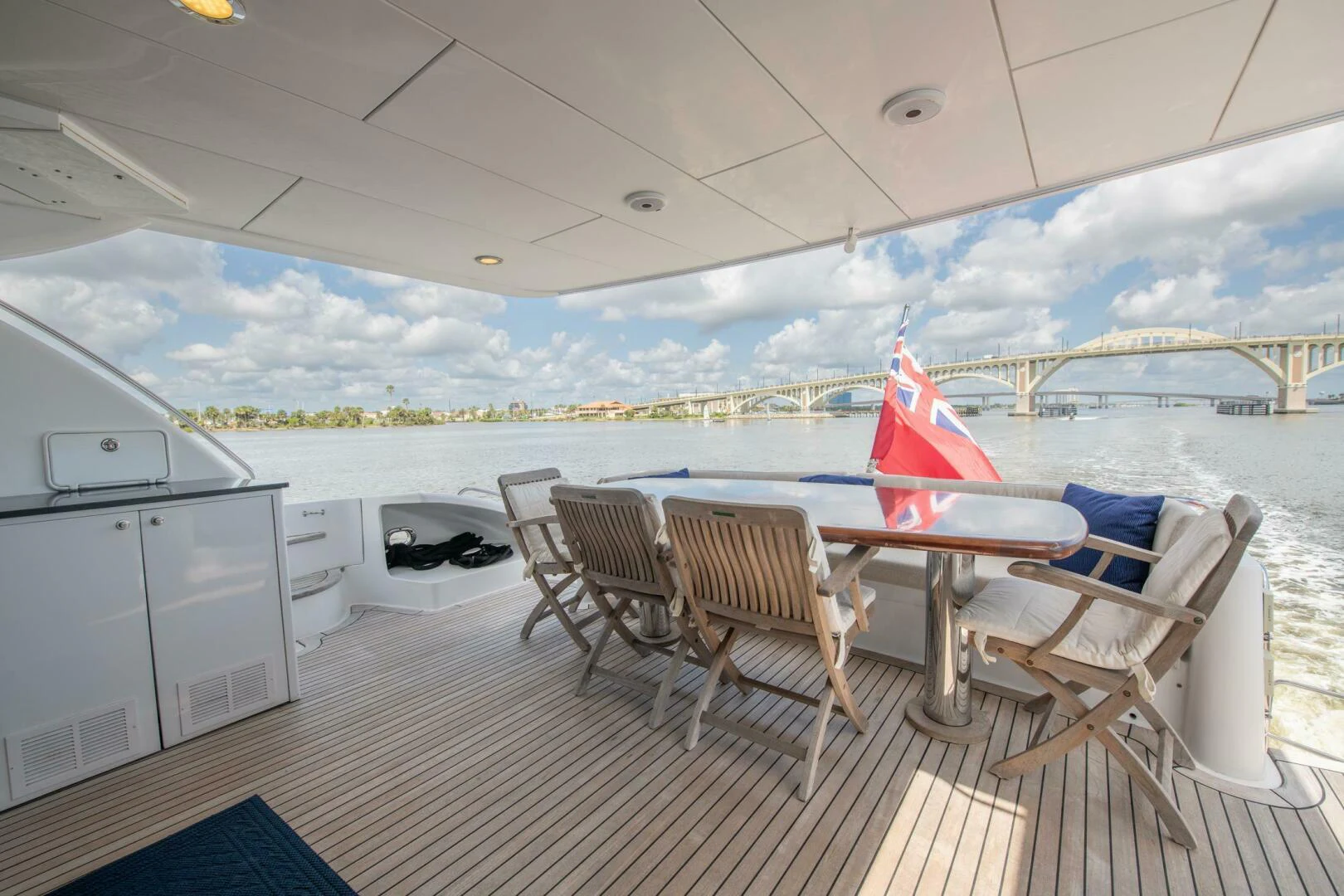 a deck with a table and chairs aboard TIME-2 FLY Yacht for Sale