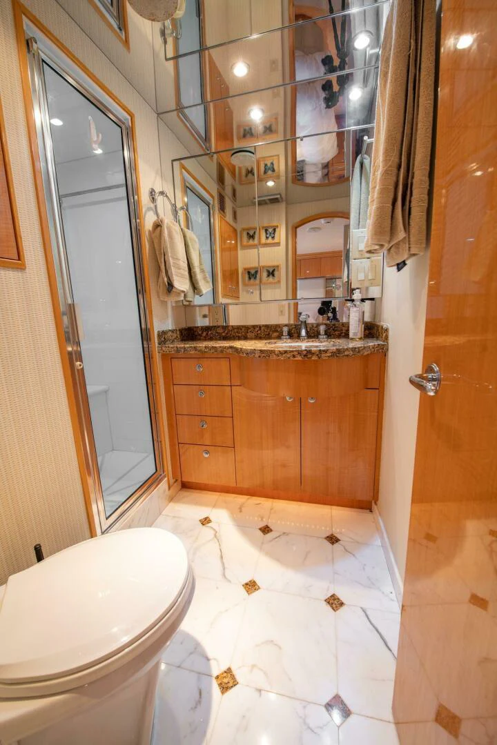 a bathroom with a toilet and a sink aboard TIME-2 FLY Yacht for Sale