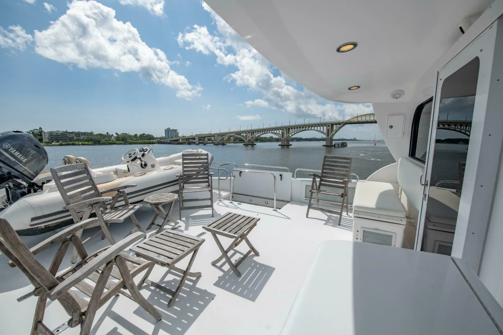 a deck with chairs and a table on it aboard TIME-2 FLY Yacht for Sale