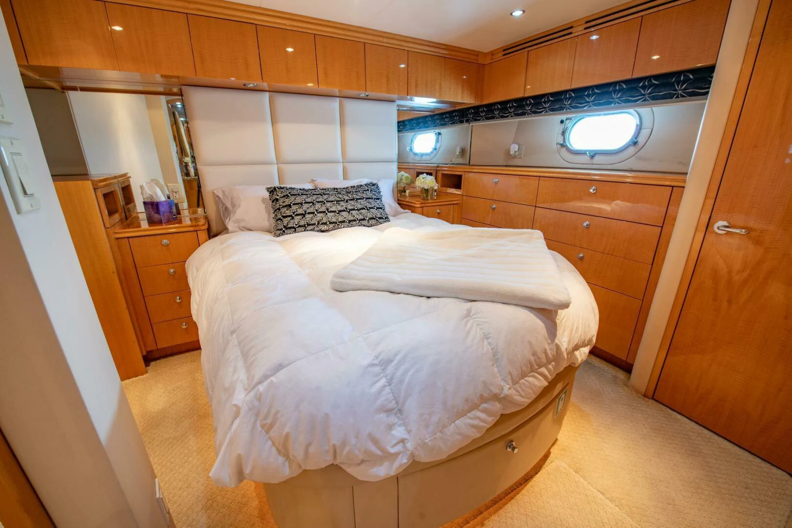 a bedroom with a bed and cabinets aboard TIME-2 FLY Yacht for Sale