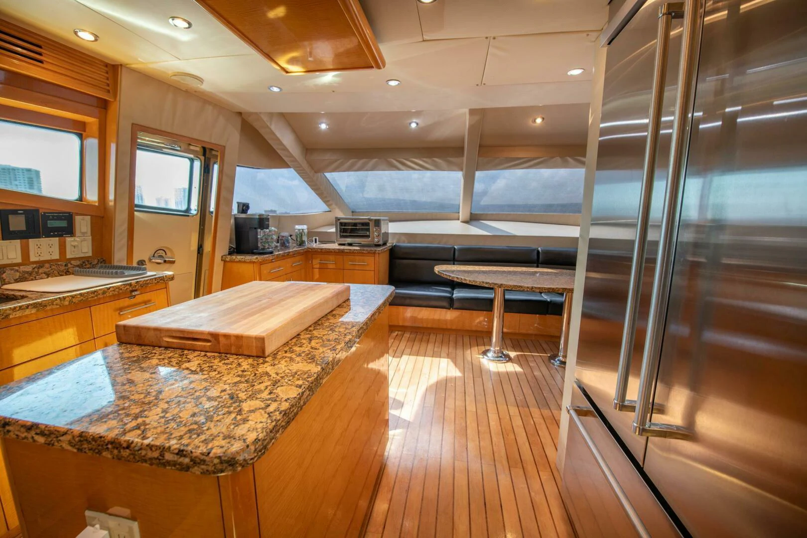 a room with a wood floor and a large glass wall with windows aboard TIME-2 FLY Yacht for Sale