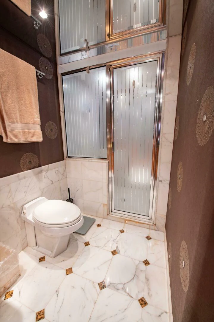 a bathroom with a toilet and a shower aboard TIME-2 FLY Yacht for Sale