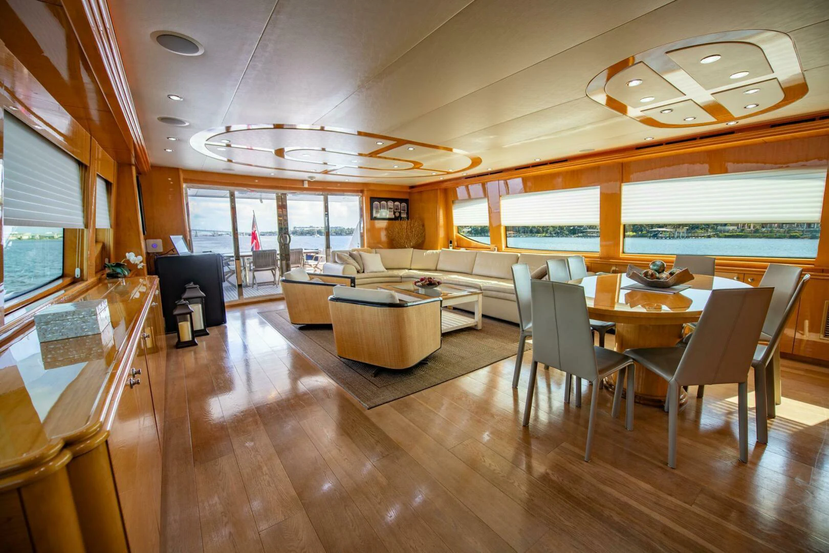 a large living room with a wood floor and a large window aboard TIME-2 FLY Yacht for Sale