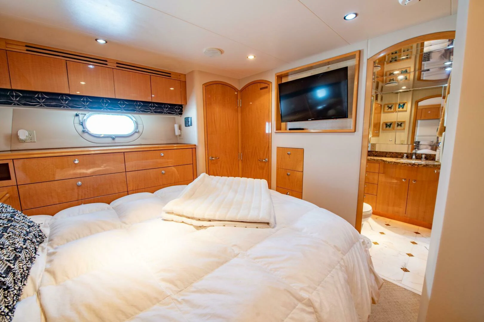 a bedroom with a bed and a television aboard TIME-2 FLY Yacht for Sale