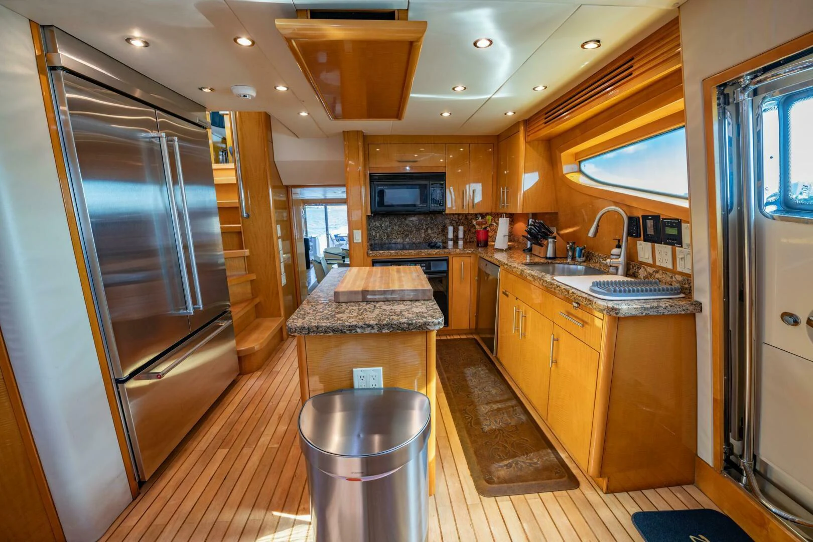 a kitchen with a bar and a table aboard TIME-2 FLY Yacht for Sale