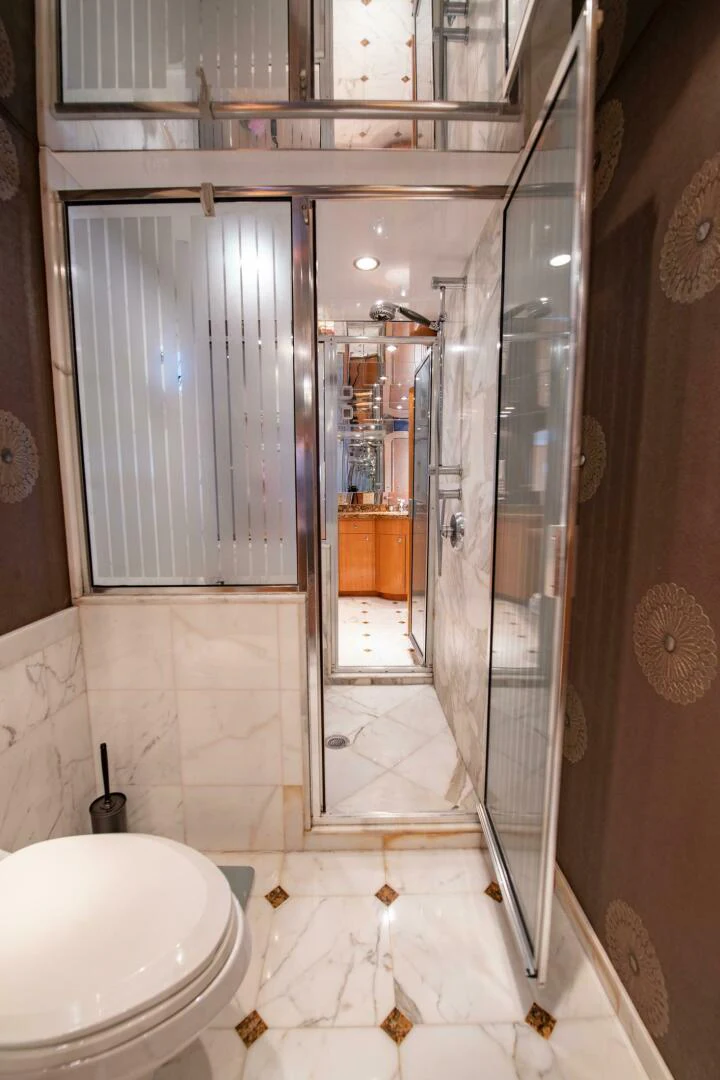 a bathroom with a glass shower aboard TIME-2 FLY Yacht for Sale