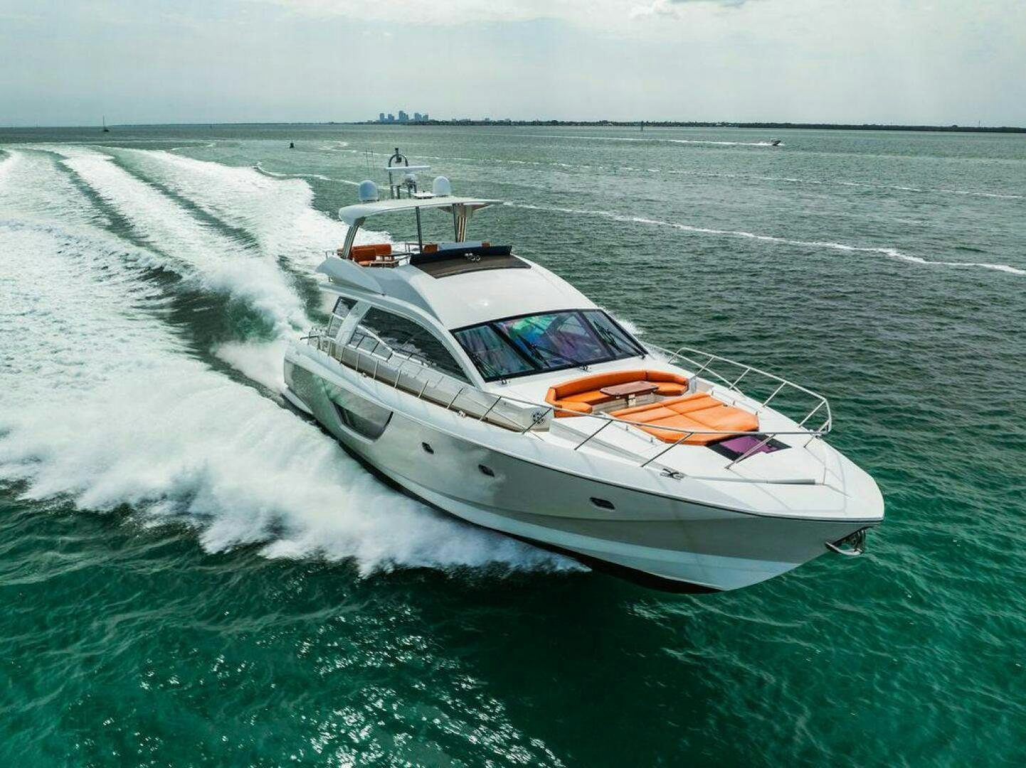 a white boat on the water aboard KNOT GUILTY Yacht for Sale