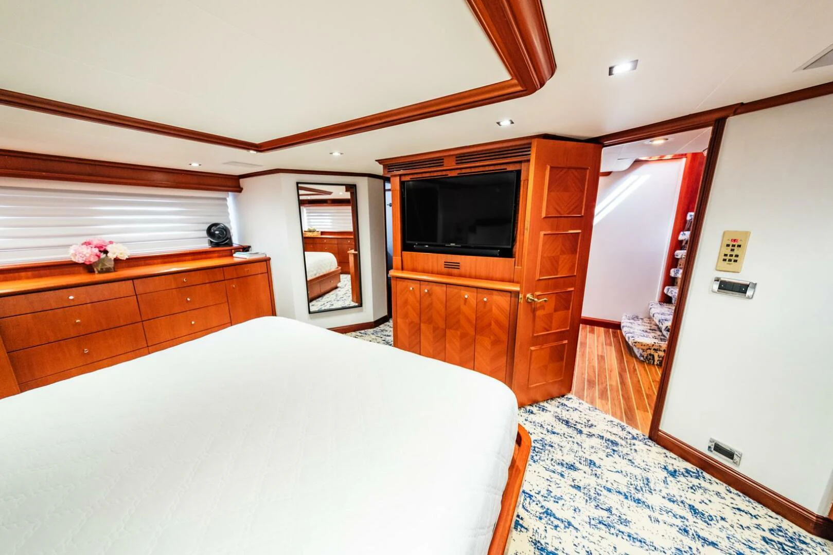 a bedroom with a bed and a television aboard GRACE Yacht for Sale