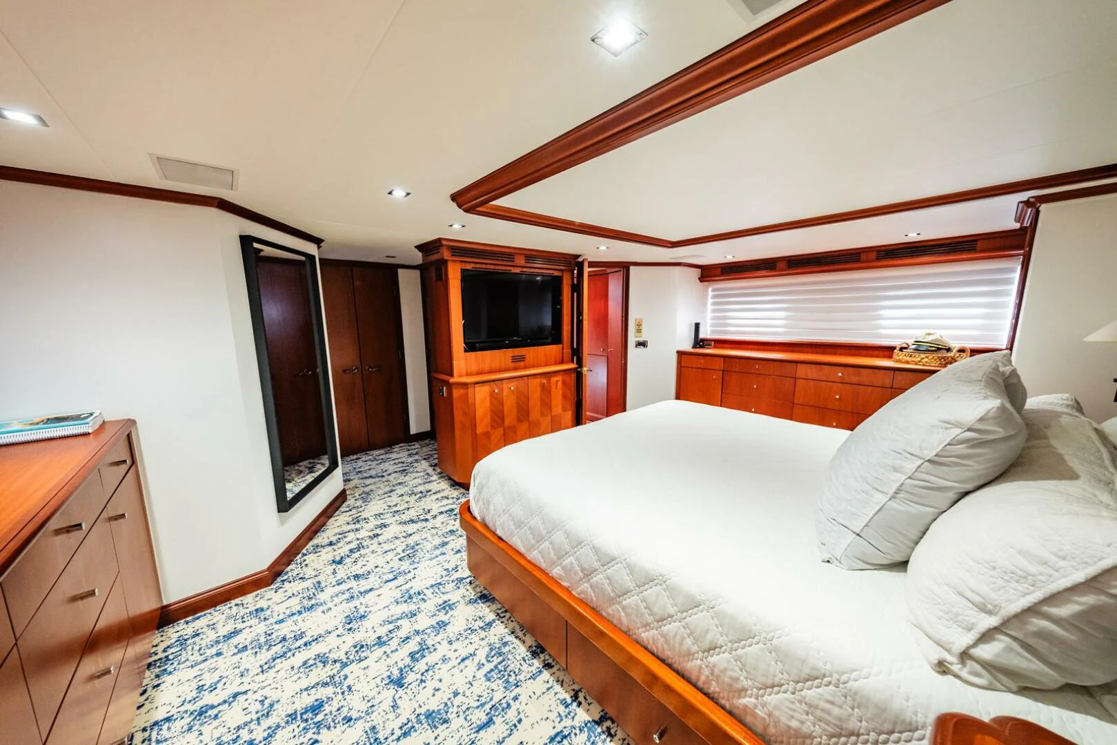 a bedroom with a bed and a television aboard GRACE Yacht for Sale
