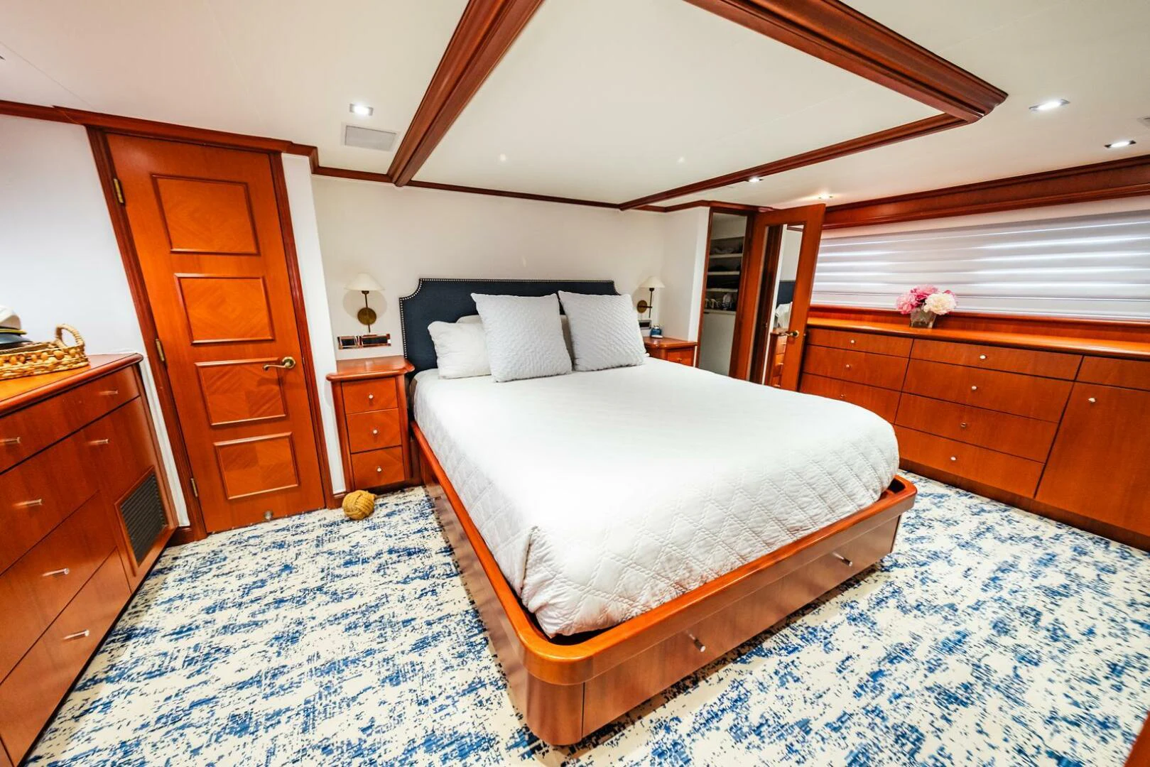 a bedroom with a bed and a dresser aboard GRACE Yacht for Sale