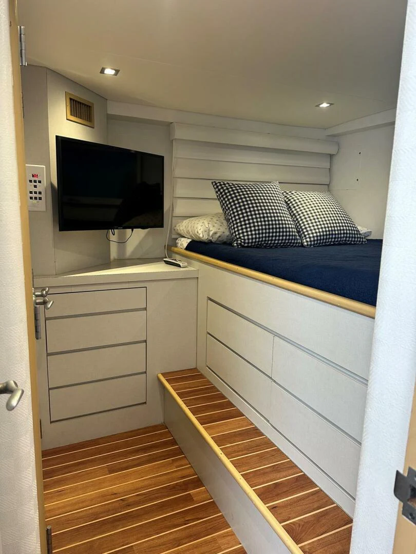 a bedroom with a bed and a tv aboard GRACE Yacht for Sale