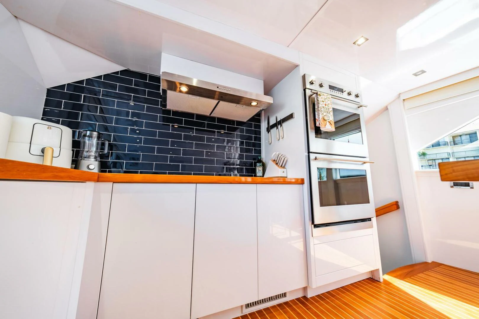 a kitchen with white cabinets aboard GRACE Yacht for Sale
