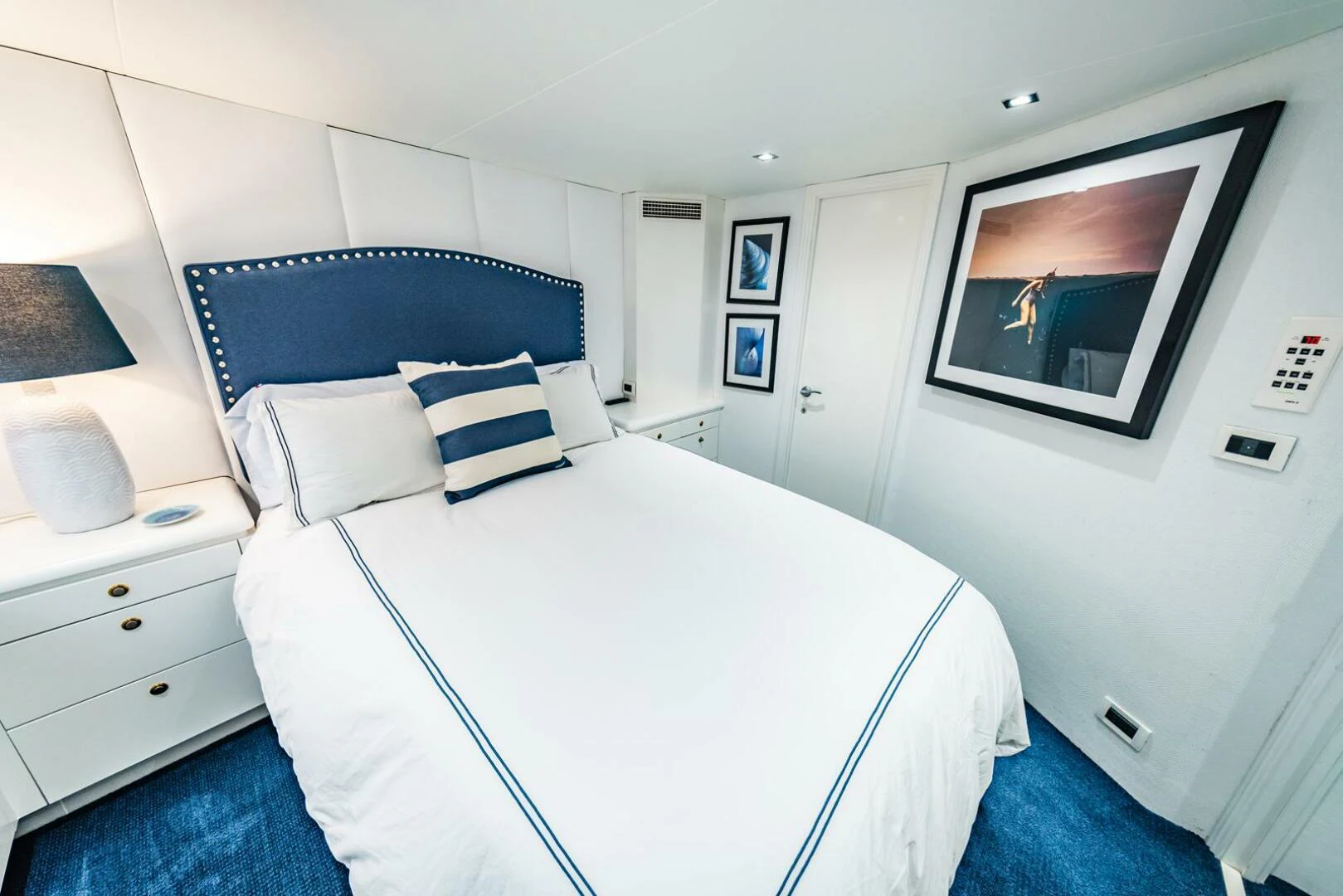 a bed with a white sheet and pillows aboard GRACE Yacht for Sale