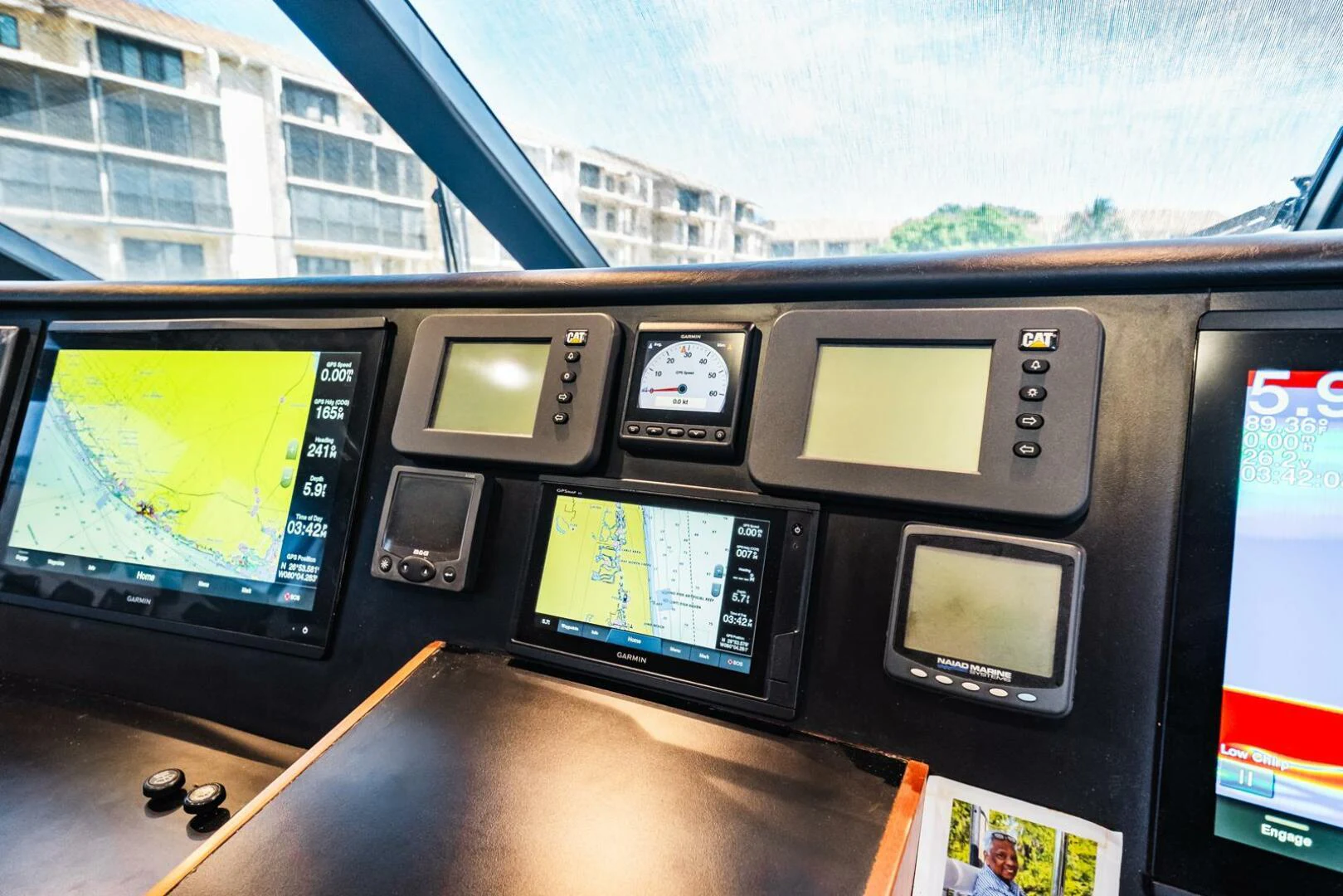 a desk with a computer and monitors aboard GRACE Yacht for Sale