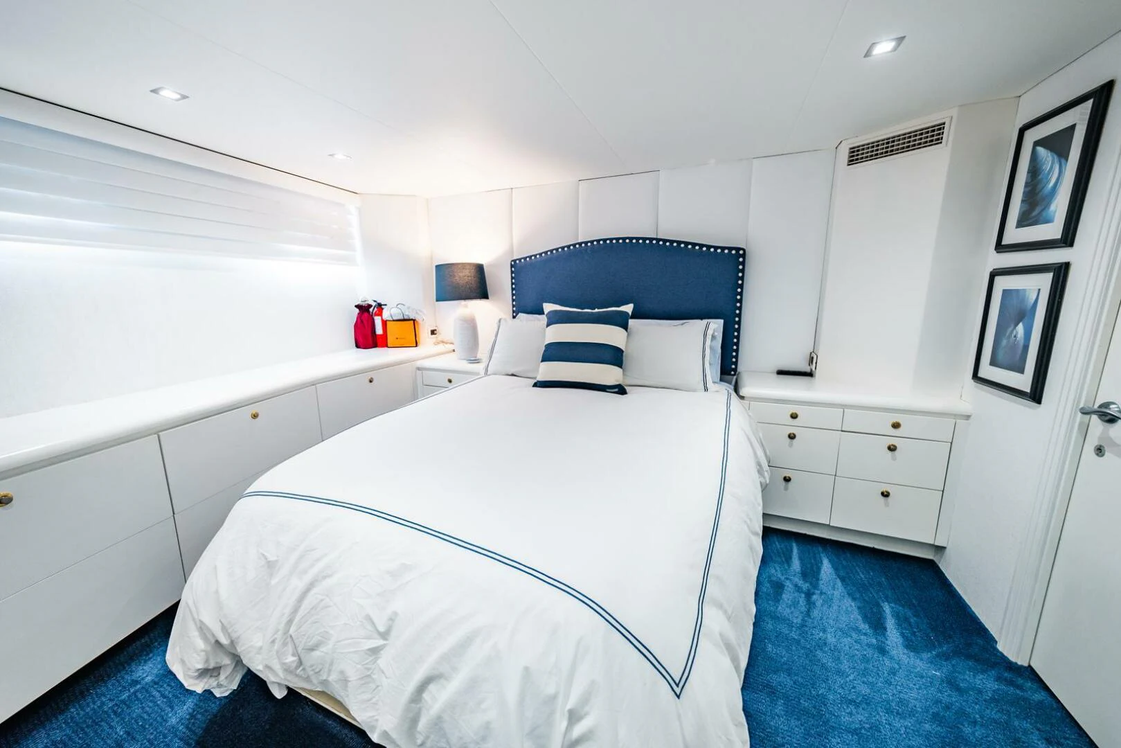 a bedroom with a blue bed spread aboard GRACE Yacht for Sale