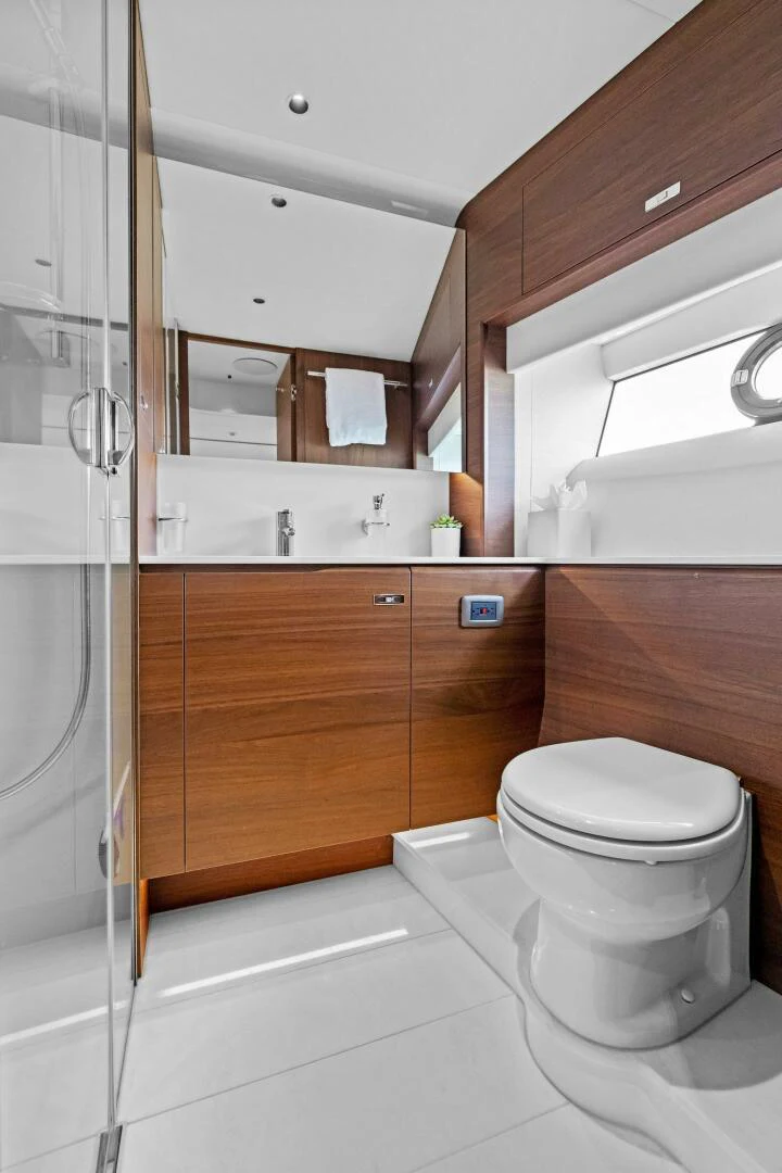 a bathroom with a glass shower aboard RAW BAR Yacht for Sale