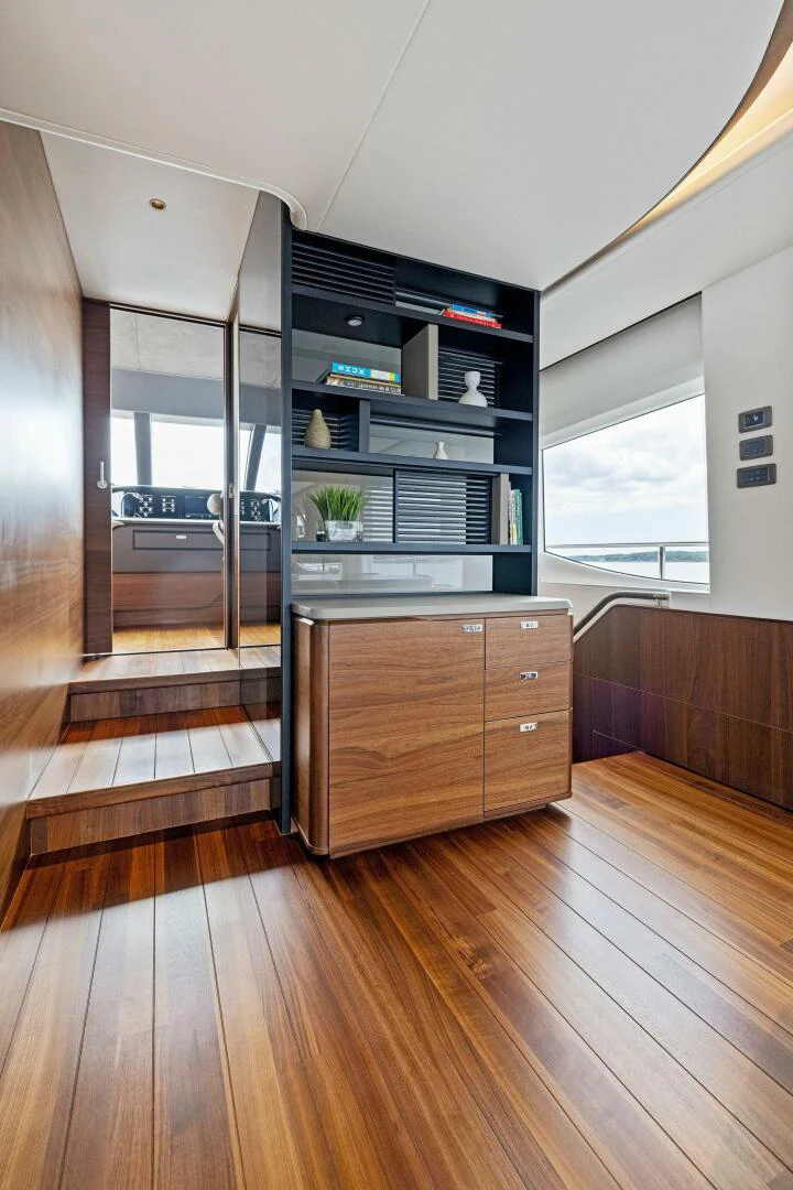 a room with a wood floor and a glass door aboard RAW BAR Yacht for Sale