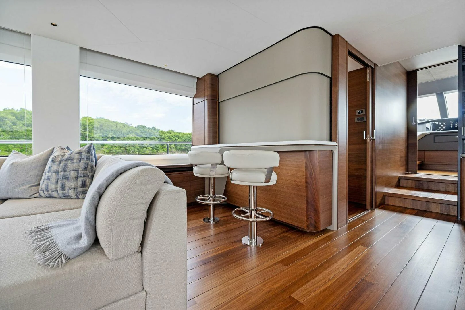 a room with a couch and a table and a chair aboard RAW BAR Yacht for Sale