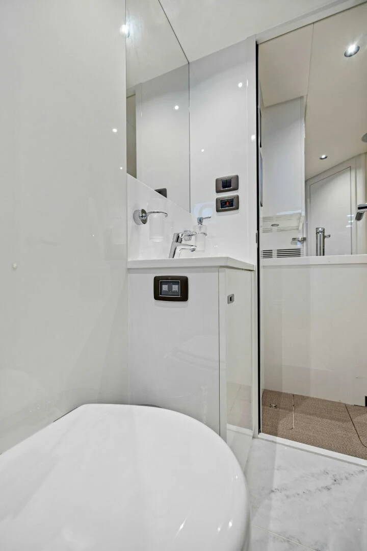 a bathroom with a toilet and a sink aboard RAW BAR Yacht for Sale