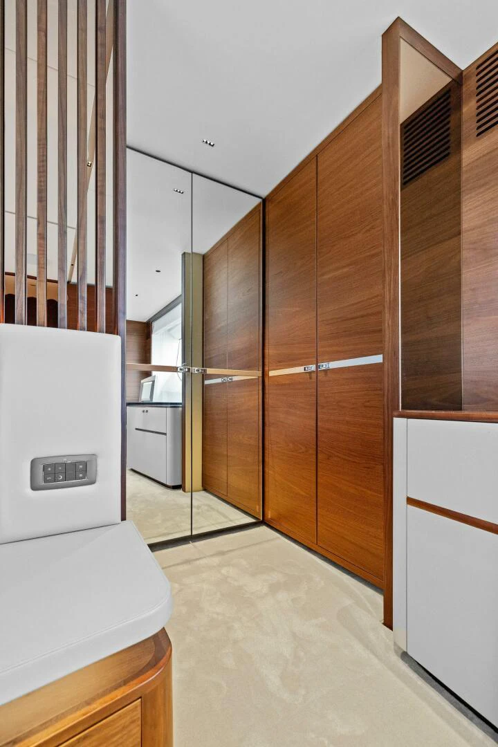a room with a refrigerator and cabinets aboard RAW BAR Yacht for Sale