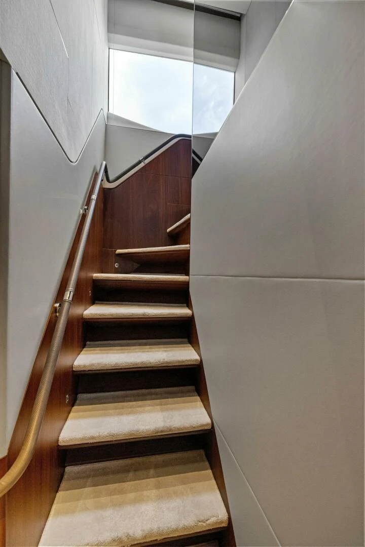 a staircase with a window aboard RAW BAR Yacht for Sale
