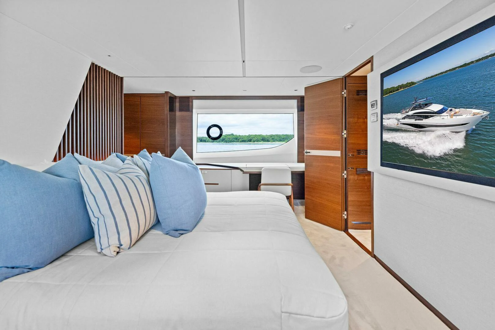 a bedroom with a large window aboard RAW BAR Yacht for Sale