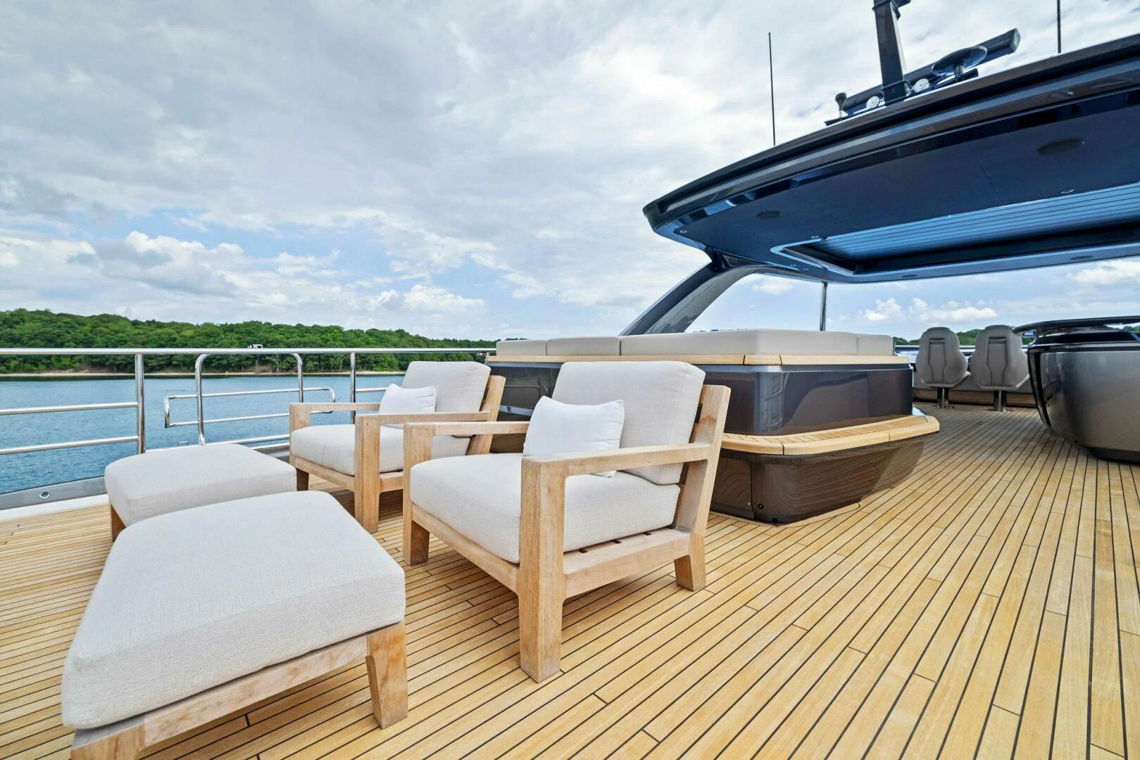 a deck with a deck and chairs on it aboard RAW BAR Yacht for Sale