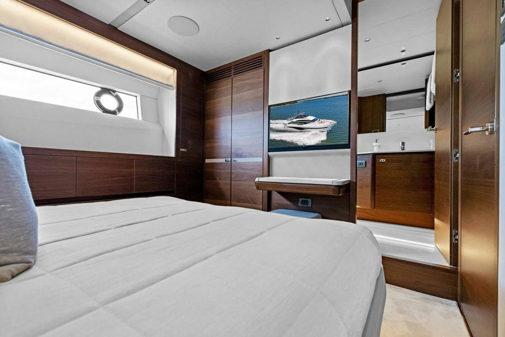 a room with a bed and a television aboard RAW BAR Yacht for Sale