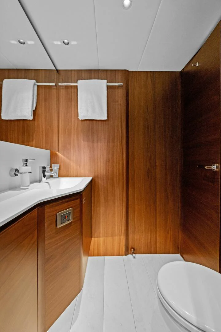 a bathroom with wooden cabinets aboard RAW BAR Yacht for Sale