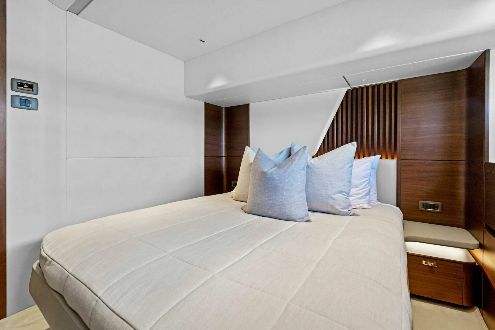 a bed with white sheets aboard RAW BAR Yacht for Sale