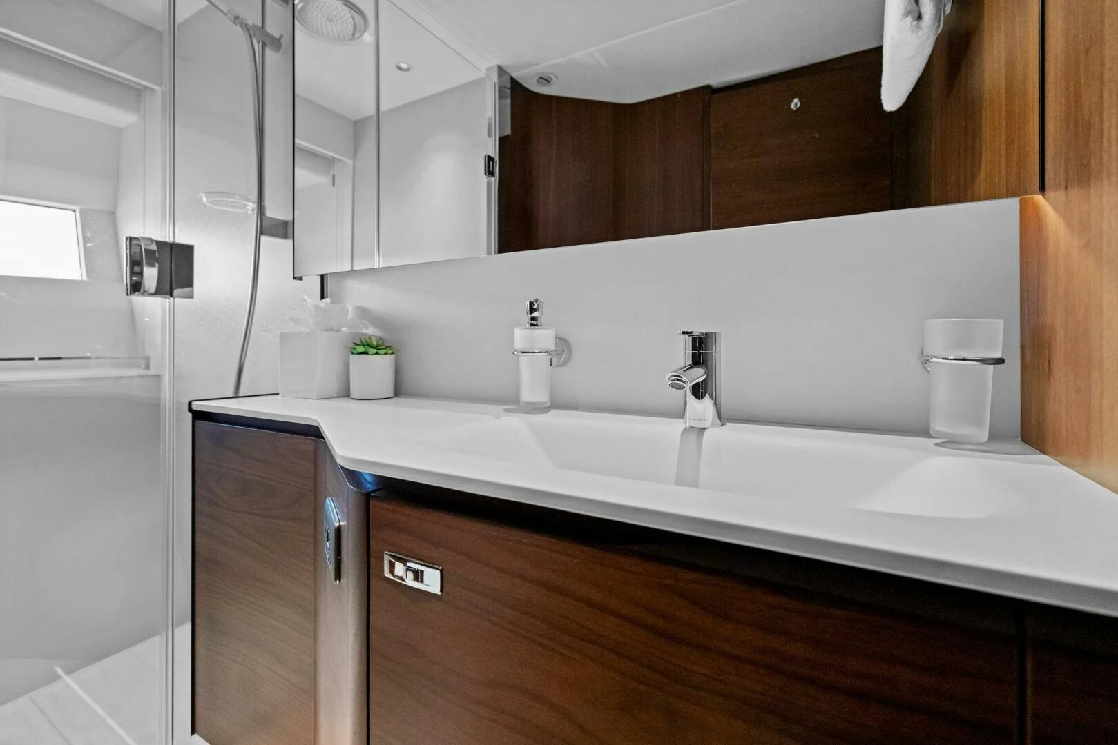 a bathroom with a sink and a mirror aboard RAW BAR Yacht for Sale